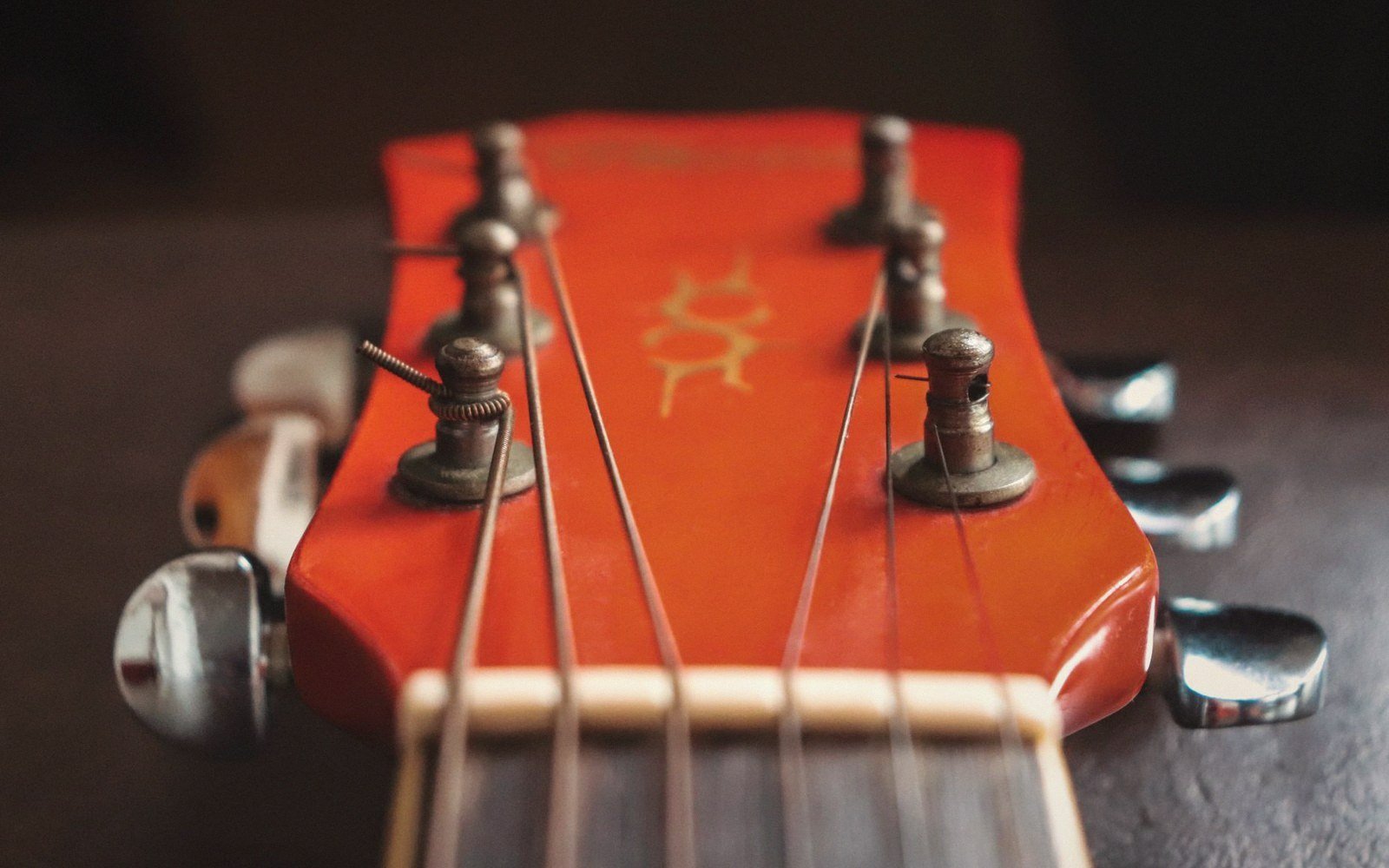 A resonator guitar's metal back catching low sun