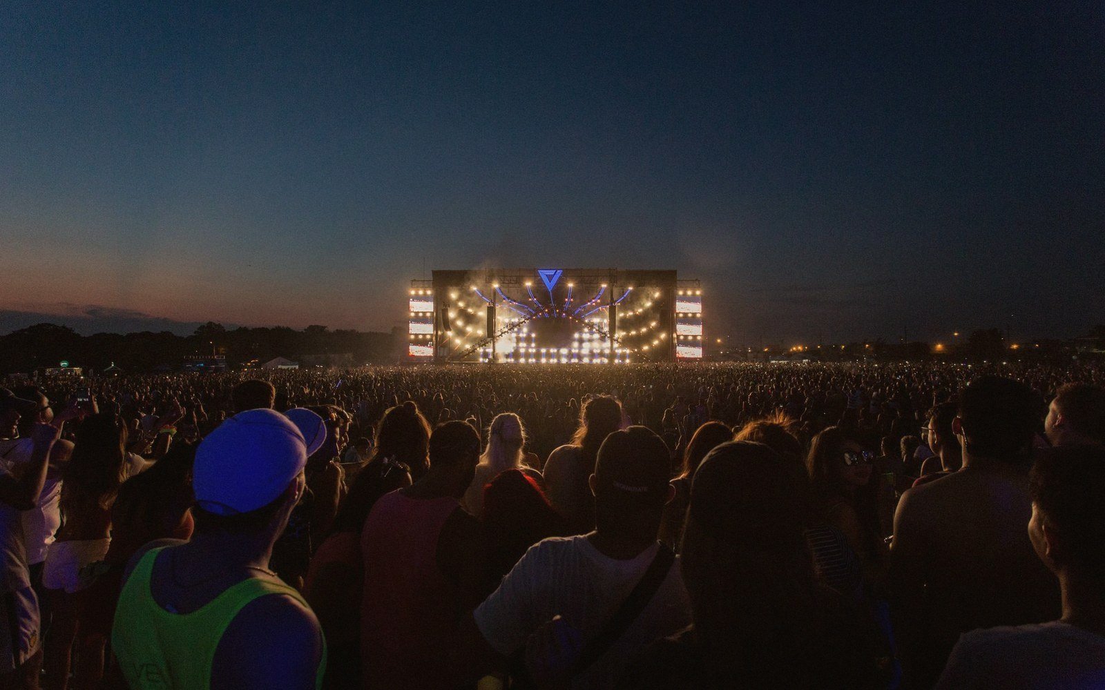 A small festival stage lit at dusk, no audience